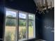 Bright room features large windows that provide expansive views and a contemporary chandelier at 126 Harvest Ln, Pittsboro, NC 27312