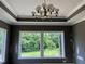 Stylish room showcasing large windows overlooking a lush yard and a contemporary light fixture at 126 Harvest Ln, Pittsboro, NC 27312