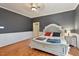 Spacious bedroom with hardwood floors, ceiling fan, and large bed at 214 College St, Oxford, NC 27565