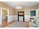 Charming living room featuring hardwood floors, fireplace, and decorative chandelier at 214 College St, Oxford, NC 27565