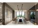 Elegant dining room with a long table, modern light fixture, and large windows showcasing natural views at 5909 Tower Grove Dr, Raleigh, NC 27614