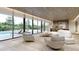 Open-concept living room with large windows, modern furnishings, and views of the pool and outdoor space at 5909 Tower Grove Dr, Raleigh, NC 27614