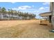 A spacious backyard with a covered porch and a large expanse of trees at 90 Bold Dr, Youngsville, NC 27596