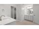 Bathroom features dual sinks, tile floors, and closet space with shelving at 90 Bold Dr, Youngsville, NC 27596