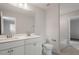 Modern bathroom featuring double sinks, white cabinets, and a large mirror at 90 Bold Dr, Youngsville, NC 27596