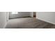 Spacious bedroom with soft gray carpeting, and natural light from the window at 90 Bold Dr, Youngsville, NC 27596