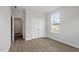 Bedroom with double closet doors, a window, neutral walls, and light wood-look floors at 90 Bold Dr, Youngsville, NC 27596