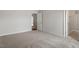 Neutral bedroom with wall-to-wall carpeting, and doorways to a hallway and closet at 90 Bold Dr, Youngsville, NC 27596