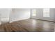 A spacious bedroom showcases luxury vinyl plank flooring and two large windows for plenty of natural light at 90 Bold Dr, Youngsville, NC 27596