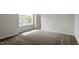 Cozy bedroom featuring carpet, a window with a view, and a doorway to another area at 90 Bold Dr, Youngsville, NC 27596