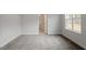 Light-filled bedroom with a soft carpet, with an adjacent bathroom visible through doorway at 90 Bold Dr, Youngsville, NC 27596