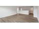 Hallway with wood-look floors, neutral walls, and an entrance to a bathroom and bedrooms at 90 Bold Dr, Youngsville, NC 27596