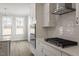This Kitchen features a quartz countertop, subway tile backsplash, white cabinets, stainless oven, and hardwood flooring at 90 Bold Dr, Youngsville, NC 27596