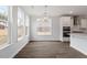 Bright open concept kitchen featuring hardwood floors, stainless appliances, white cabinetry, and natural light at 90 Bold Dr, Youngsville, NC 27596
