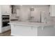 Modern kitchen features stainless appliances, a large quartz island, white cabinets, hardwood floors, and a subway tile backsplash at 90 Bold Dr, Youngsville, NC 27596