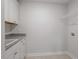 Functional laundry area with white cabinets, granite countertops, and ample storage space at 90 Bold Dr, Youngsville, NC 27596