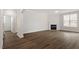 Bright living room features a fireplace, large windows, and stylish wood-look flooring at 90 Bold Dr, Youngsville, NC 27596