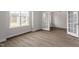 Bright living room features double French doors, wood-look floors, and abundant light at 90 Bold Dr, Youngsville, NC 27596