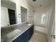 Bathroom featuring a double vanity, granite countertops, and a shower-tub combination at 247 Jenkins St, Erwin, NC 28334