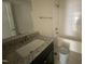 Bathroom featuring granite counters, modern fixtures, and tiled shower, blending style and functionality at 247 Jenkins St, Erwin, NC 28334