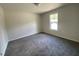 A bright bedroom with a carpet floor and a window overlooking the outdoors at 247 Jenkins St, Erwin, NC 28334