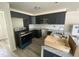 Modern kitchen with stainless steel appliances, granite countertops, and dark wood cabinetry at 247 Jenkins St, Erwin, NC 28334