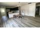 Open-concept living area connecting to the kitchen, with a stylish chandelier and natural light at 247 Jenkins St, Erwin, NC 28334