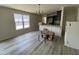 Open-concept living area connecting to the kitchen, with a stylish chandelier and natural light at 247 Jenkins St, Erwin, NC 28334
