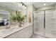 Modern bathroom featuring double sinks, a large mirror, and a glass-enclosed shower at 191 Anise Ln, Garner, NC 27529