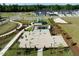 Aerial view of a beautifully landscaped community area with benches, games, picnic tables, playground and homes at 191 Anise Ln, Garner, NC 27529