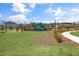 Manicured community area with a playground, picnic tables, walking path and homes at 191 Anise Ln, Garner, NC 27529