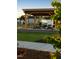 Outdoor community space with picnic tables, wooden pergola, and stone fire place at 191 Anise Ln, Garner, NC 27529