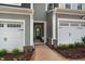 Inviting entrance to the townhome with a brick walkway, well-manicured landscaping, and a welcoming front door at 191 Anise Ln, Garner, NC 27529