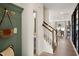 Inviting entryway featuring wood floors, a stylish sage green wall, and staircase leading to the upper level at 191 Anise Ln, Garner, NC 27529