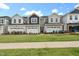 Charming townhome exteriors feature modern design, well-maintained lawns, and two car garages at 191 Anise Ln, Garner, NC 27529