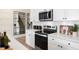 This modern kitchen boasts white cabinets, sleek countertops, and stainless steel appliances for a stylish and functional space at 191 Anise Ln, Garner, NC 27529