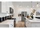 Modern kitchen featuring sleek, white cabinets, stainless steel appliances, and ample counter space for meal preparation at 191 Anise Ln, Garner, NC 27529