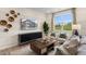 Cozy living room with stylish decor, a modern entertainment center, and a scenic view from the bright window at 191 Anise Ln, Garner, NC 27529