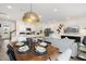 Open-concept living and kitchen area showcasing a dining table for entertaining, along with bright white cabinets at 191 Anise Ln, Garner, NC 27529