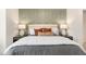 Luxurious bedroom features a decorative accent wall, plush bedding, and stylish bedside lamps at 191 Anise Ln, Garner, NC 27529