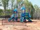 Community playground equipment with slides and climbing features is surrounded by a black metal fence at 191 Anise Ln, Garner, NC 27529