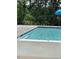 Community pool with easy access, features a light blue interior and is surrounded by a concrete deck at 191 Anise Ln, Garner, NC 27529