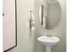 Pedestal sink with chrome fixtures in a modern, neutral-toned powder room at 191 Anise Ln, Garner, NC 27529