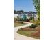 Curving sidewalk through a well landscaped common area, leading to community amenities at 191 Anise Ln, Garner, NC 27529