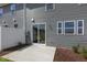 Backyard view of townhome with patio, lawn, and gray siding at 195 Anise Ln, Garner, NC 27529