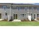 Backyard view of townhome with patio, lawn, and gray siding at 195 Anise Ln, Garner, NC 27529