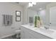Bright bathroom featuring a double sink vanity with white cabinets and light countertops at 195 Anise Ln, Garner, NC 27529