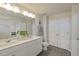 Bright bathroom featuring a double sink vanity, white cabinets, and grey wood-look flooring at 195 Anise Ln, Garner, NC 27529