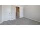 Carpeted bedroom showcasing neutral walls and trim with a doorway leading to the next room at 195 Anise Ln, Garner, NC 27529