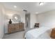 Spacious bedroom featuring neutral decor, a decorative mirror, and a cozy woven chair at 195 Anise Ln, Garner, NC 27529